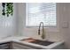 Kitchen features a stainless steel sink, modern faucet, white subway tile backsplash, and marble countertop at 4282 Roswell Ne Rd # G1, Atlanta, GA 30342