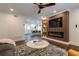 Cozy living room with electric fireplace, TV, and access to an open kitchen space at 4282 Roswell Ne Rd # G1, Atlanta, GA 30342