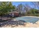 Outdoor pool with trees and apartment building in the background at 4282 Roswell Ne Rd # G1, Atlanta, GA 30342