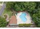Aerial shot shows the pool, treed area, lounge chairs, and landscaping at 4815 Rapids Nw Cir, Acworth, GA 30102