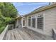 A large wood back deck with access doors and windows looking over the lush backyard at 4815 Rapids Nw Cir, Acworth, GA 30102