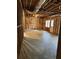 Unfinished basement with exposed wooden framing and concrete floor, with a door to the outside at 4815 Rapids Nw Cir, Acworth, GA 30102
