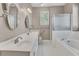 Bathroom featuring a double sink vanity, glass enclosed shower, and soaking tub at 4815 Rapids Nw Cir, Acworth, GA 30102