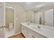 Bright bathroom featuring a double vanity, large mirror, and separate toilet area at 4815 Rapids Nw Cir, Acworth, GA 30102