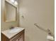 Half bath with a single sink vanity, framed mirror, and accessibility bar at 4815 Rapids Nw Cir, Acworth, GA 30102