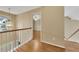 Upstairs hallway with hardwood flooring, natural light, and views of the entryway and stairwell at 4815 Rapids Nw Cir, Acworth, GA 30102
