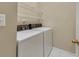 Functional laundry room featuring a side-by-side washer and dryer and wire shelving at 4815 Rapids Nw Cir, Acworth, GA 30102