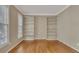 Living room with hardwood floors, two windows, and built-in bookshelves at 4815 Rapids Nw Cir, Acworth, GA 30102