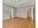 Spacious main bedroom featuring hardwood floors, neutral paint, and a tray ceiling with fan at 4815 Rapids Nw Cir, Acworth, GA 30102