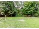 Spacious backyard featuring lush lawn, mature trees, and a soccer goal for outdoor fun and recreation at 1921 Northbrooke Ln, Dunwoody, GA 30338