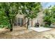 Backyard featuring a patio with a grill, table and chairs and a hammock between trees at 1921 Northbrooke Ln, Dunwoody, GA 30338