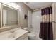 Bathroom featuring a vanity, toilet, and shower/tub combo with a purple shower curtain at 1921 Northbrooke Ln, Dunwoody, GA 30338