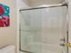 Bathroom with a clear glass enclosed shower, toilet, and a painting with a flamingo on the wall at 1921 Northbrooke Ln, Dunwoody, GA 30338