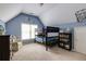 Blue colored bedroom featuring a bunk bed, bookcase, a chair, and a vaulted ceiling at 1921 Northbrooke Ln, Dunwoody, GA 30338