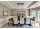 Cozy dining room with a long table, chandelier, and large windows at 1921 Northbrooke Ln, Dunwoody, GA 30338