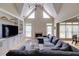 Bright living room with vaulted ceiling, fireplace, and built-in shelving at 1921 Northbrooke Ln, Dunwoody, GA 30338