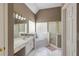 Relaxing bathroom with dual sinks, a glass block window, and a separate shower and tub at 1921 Northbrooke Ln, Dunwoody, GA 30338