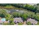 Aerial view of complex nestled amidst lush greenery next to a beautiful lake at 2214 Lake Pointe Cir, Roswell, GA 30075