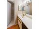 Well-lit bathroom with vanity, framed mirror and view to a separate shower and tub at 2214 Lake Pointe Cir, Roswell, GA 30075