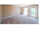 Spacious bedroom with carpet, ceiling fan, and door to balcony at 2214 Lake Pointe Cir, Roswell, GA 30075