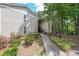 View of home's exterior with beautiful green landscape and manicured lawn at 2214 Lake Pointe Cir, Roswell, GA 30075