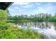 Picturesque lake view with lush greenery and reflections of the sky at 2214 Lake Pointe Cir, Roswell, GA 30075