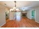 Open concept living room with fireplace, wood floors, dining area and stainless steel appliances at 2214 Lake Pointe Cir, Roswell, GA 30075