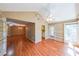 Inviting living room boasting vaulted ceiling, wood floors, and adjoining kitchen and dining areas at 2214 Lake Pointe Cir, Roswell, GA 30075