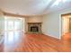 Cozy living room with wood floors, stone fireplace, and lots of natural light from surrounding windows at 2214 Lake Pointe Cir, Roswell, GA 30075