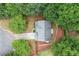 Aerial view of a house showcasing a large roof, surrounded by lush trees, and a well manicured lawn at 2711 Brookefield Nw Ln, Kennesaw, GA 30152