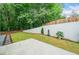 Wide backyard featuring a concrete wall, privacy fence, green grass, landscaping, and mulch groundcover at 2711 Brookefield Nw Ln, Kennesaw, GA 30152