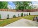 Spacious backyard featuring a concrete wall, privacy fence, green grass, and manicured landscaping at 2711 Brookefield Nw Ln, Kennesaw, GA 30152