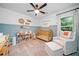 Cozy Bedroom featuring a charming crib, comfortable armchair, and playful decor on wainscotting at 2711 Brookefield Nw Ln, Kennesaw, GA 30152