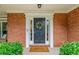 A welcoming front door with a wreath, flanked by sidelights and neat green shrubbery at 2711 Brookefield Nw Ln, Kennesaw, GA 30152