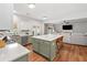 Open-concept kitchen with an island, stainless steel appliances, and view to the living room at 2711 Brookefield Nw Ln, Kennesaw, GA 30152