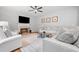Living room features hardwood floors, a ceiling fan, sofa and view of the fireplace and television at 2711 Brookefield Nw Ln, Kennesaw, GA 30152