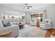 Open floor plan living room features large sectional sofa, hardwood flooring and view into kitchen at 2711 Brookefield Nw Ln, Kennesaw, GA 30152