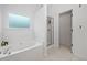 Main bathroom features a tub, a separate shower and a frosted window at 2711 Brookefield Nw Ln, Kennesaw, GA 30152