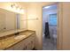 Bathroom featuring single sink with granite countertop and view of tub and shower at 2821 Ne Meadowlark Trail, Duluth, GA 30096