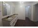 Bathroom featuring double sinks with granite countertops and modern lighting at 2821 Ne Meadowlark Trail, Duluth, GA 30096