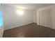 An inviting bedroom features wood floors, neutral walls, and closet with folding louvered doors at 2821 Ne Meadowlark Trail, Duluth, GA 30096