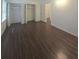Bedroom featuring closet with louvered doors and hardwood floors at 2821 Ne Meadowlark Trail, Duluth, GA 30096