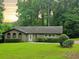 Charming single-story brick home with a well-manicured lawn and mature landscaping, perfect for Gathering living at 2821 Ne Meadowlark Trail, Duluth, GA 30096