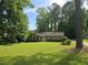 Charming single-story brick home with a well-manicured lawn and mature landscaping, perfect for Gathering living at 2821 Ne Meadowlark Trail, Duluth, GA 30096