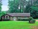 Charming single-story brick home with well-maintained lawn and mature trees at 2821 Ne Meadowlark Trail, Duluth, GA 30096