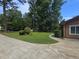 Well-maintained front yard features a lush lawn, mature trees, and a winding walkway to the home's entrance at 2821 Ne Meadowlark Trail, Duluth, GA 30096