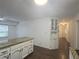 A bright kitchen featuring an island with granite countertops and white cabinetry is the heart of the home at 2821 Ne Meadowlark Trail, Duluth, GA 30096