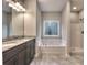 This primary bathroom features a granite double vanity and separate tub and shower at 335 Melody Ne Ln, Cartersville, GA 30121