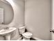 Modern powder room with sleek pedestal sink and minimalist design, perfect for guests and everyday convenience at 335 Melody Ne Ln, Cartersville, GA 30121