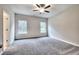 Spacious carpeted bedroom with a ceiling fan, neutral walls, and natural light from two windows at 335 Melody Ne Ln, Cartersville, GA 30121